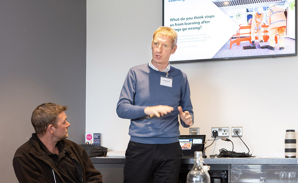 image of a staff member delivering a presentation to an audience
