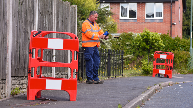 Leakage technician standing on a footpath