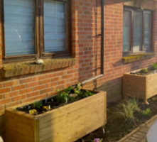 SlowFlow Planters in front of apartment blocks in Fallowfields, Cambridge